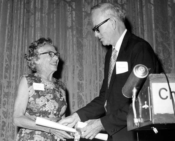 Louise L. Sloan receiving a reward